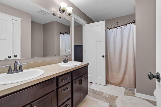 1226 1st St, Saint Paul Park, MN 55071 - full bath with a sink, stone finish floor, curtained shower, and double vanity