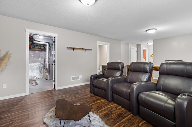 1226 1st St, Saint Paul Park, MN 55071 - home theater room with baseboards, dark wood finished floors, a textured ceiling, and visible vents