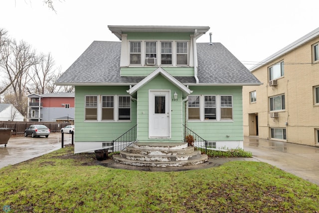 803 10th Ave N, Fargo, ND 58102 - view of front facade featuring roof with shingles, fence, and entry steps