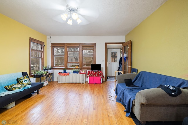 803 10th Ave N, Fargo, ND 58102 - living area with radiator, ceiling fan, and hardwood / wood-style flooring