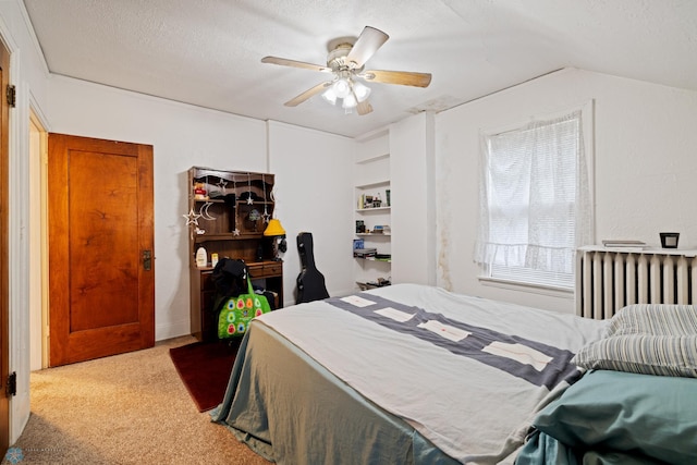803 10th Ave N, Fargo, ND 58102 - bedroom with lofted ceiling, ceiling fan, radiator heating unit, a textured ceiling, and carpet flooring