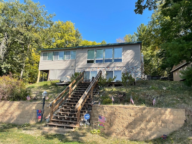 back of property featuring stairway