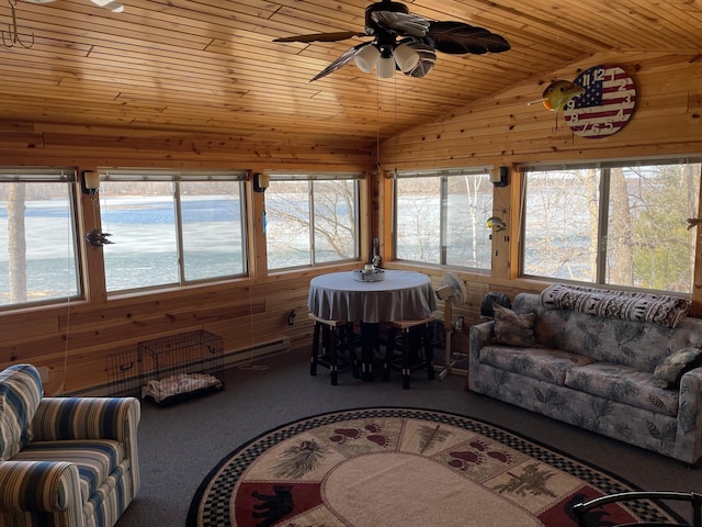 carpeted living room with wood walls, a ceiling fan, vaulted ceiling, and wooden ceiling