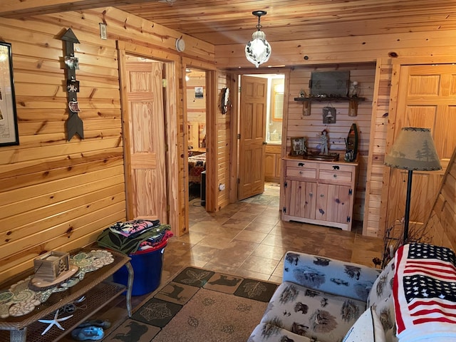interior space with tile patterned flooring, wood ceiling, and wooden walls