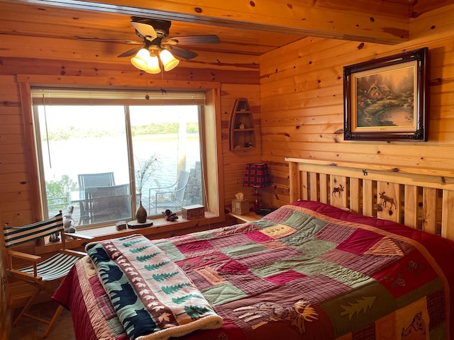 bedroom featuring wooden walls