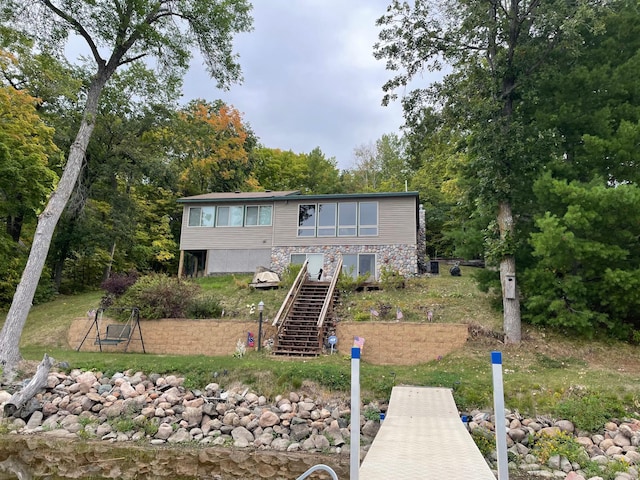 rear view of house featuring stairs