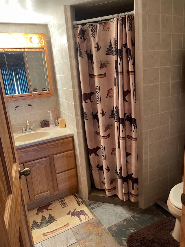 9849 Maple Ridge Rd, Garrison Twp, MN 56450 - full bath with tile walls, toilet, vanity, curtained shower, and stone finish floors