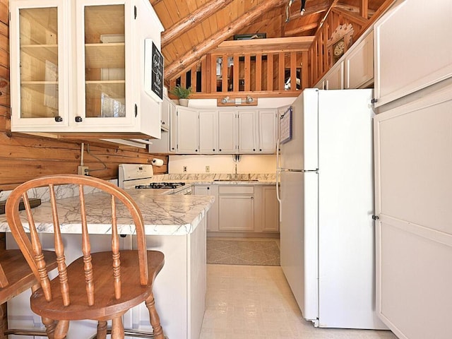 20703 Aspen Dr, Grand Rapids, MN 55744 - kitchen with light countertops, wooden ceiling, a peninsula, glass insert cabinets, and white appliances