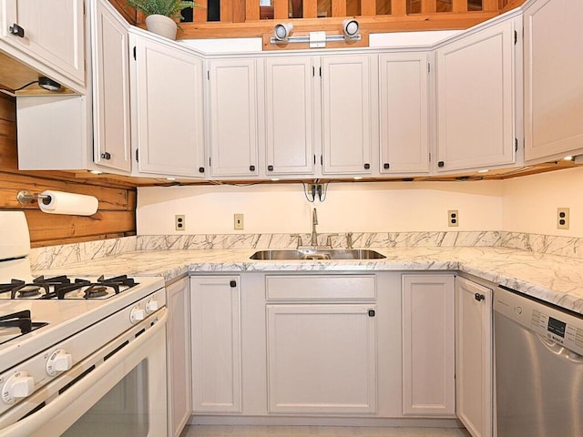 20703 Aspen Dr, Grand Rapids, MN 55744 - kitchen featuring light stone counters, a sink, white cabinetry, white range with gas stovetop, and stainless steel dishwasher
