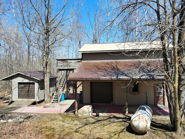 20703 Aspen Dr, Grand Rapids, MN 55744 - view of front of house with stairway, a deck, and an outdoor structure