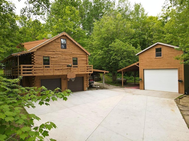 20703 Aspen Dr, Grand Rapids, MN 55744 - view of side of property featuring driveway, an attached garage, log siding, and view of scattered trees