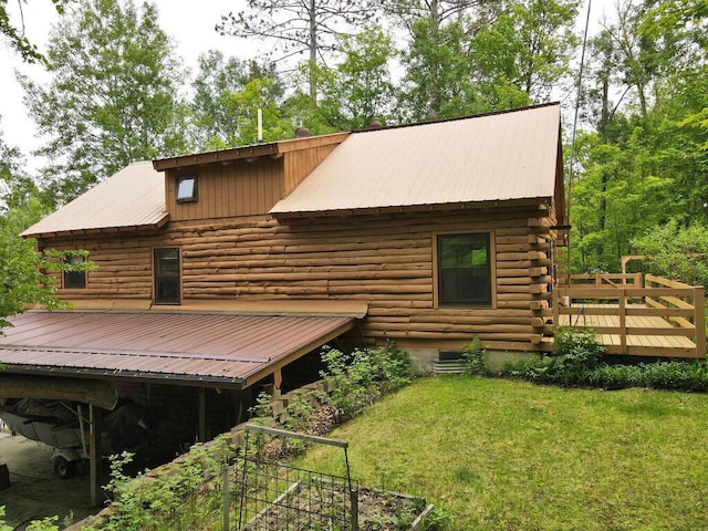 20703 Aspen Dr, Grand Rapids, MN 55744 - rear view of house with log siding, a wooden deck, a lawn, and a metal roof
