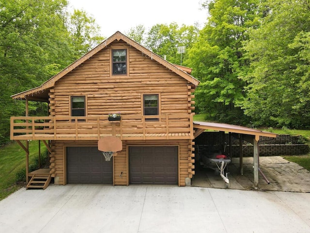 20703 Aspen Dr, Grand Rapids, MN 55744 - view of home's exterior with log exterior, an attached garage, and concrete driveway