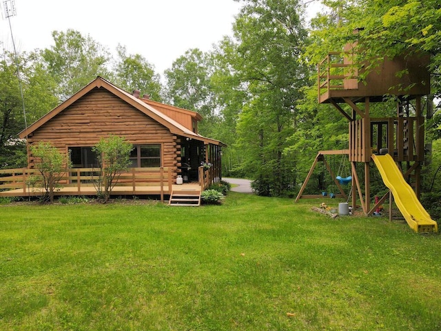 20703 Aspen Dr, Grand Rapids, MN 55744 - view of grassy yard featuring a wooden deck and a playground