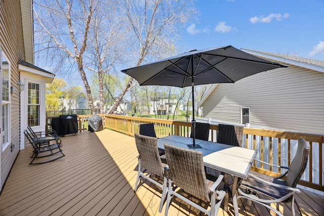 wooden terrace featuring outdoor dining area
