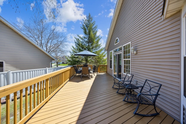wooden deck featuring outdoor dining space