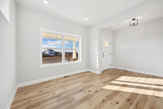 entryway with wood finished floors, recessed lighting, and baseboards