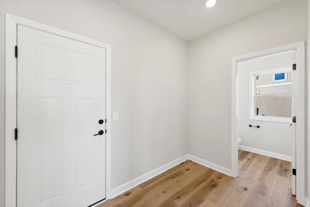 entryway featuring light wood-style flooring, baseboards, and recessed lighting