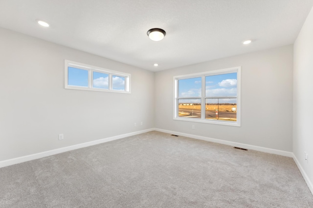 unfurnished room featuring carpet flooring, baseboards, and recessed lighting