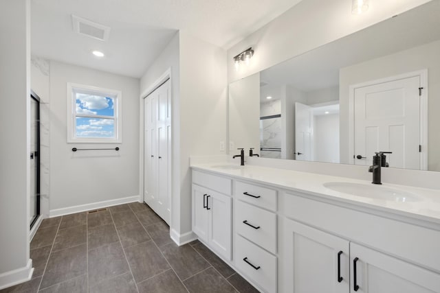 full bathroom featuring an enclosed shower, double vanity, baseboards, and recessed lighting