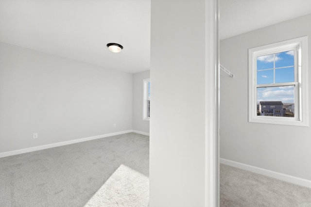unfurnished bedroom featuring carpet and baseboards