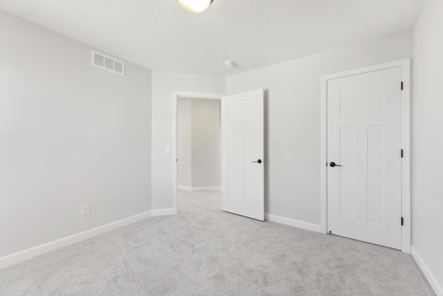 unfurnished bedroom featuring carpet flooring and baseboards