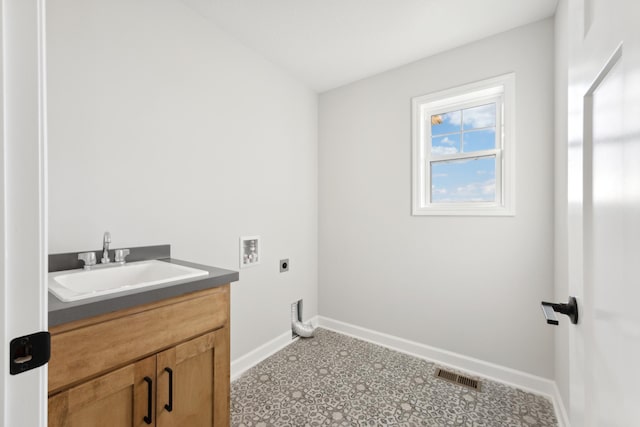clothes washing area featuring electric dryer hookup, hookup for a washing machine, baseboards, and cabinet space