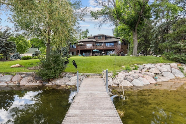 dock featuring a lawn and a deck with water view