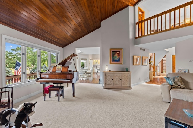 sitting room featuring carpet, baseboards, wood ceiling, high vaulted ceiling, and stairway