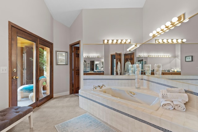 bathroom featuring a bath and baseboards