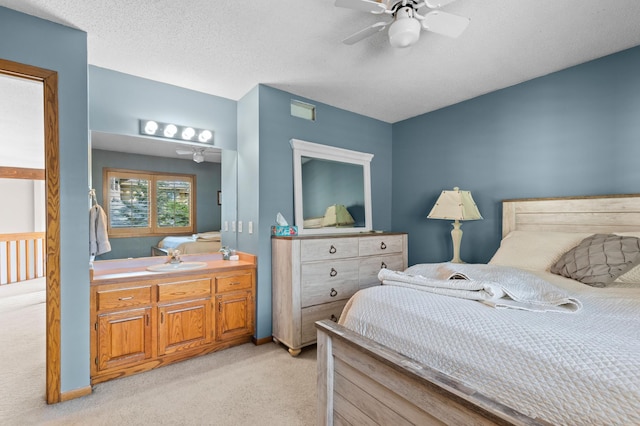 bedroom with light carpet, a sink, and a ceiling fan