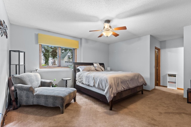 carpeted bedroom featuring a textured ceiling and a ceiling fan