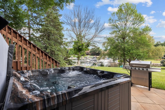 wooden terrace with a hot tub, a grill, and a yard