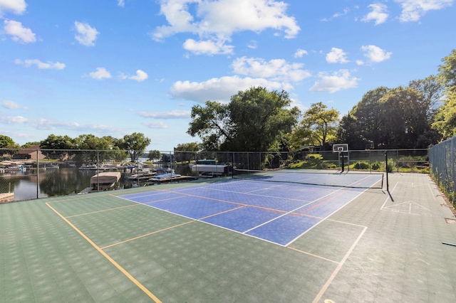 view of tennis court featuring fence and community basketball court