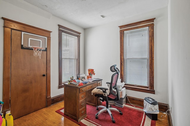 office space with light wood-style floors and baseboards