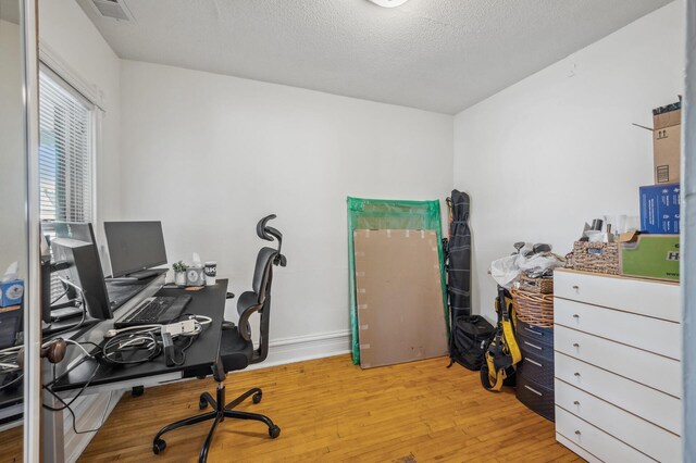 office space featuring visible vents and hardwood / wood-style floors