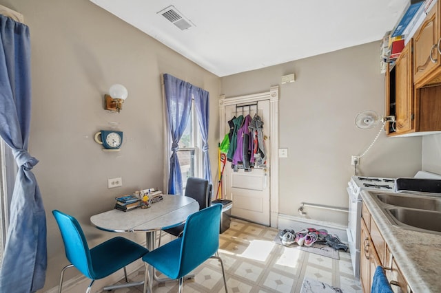 dining space featuring visible vents and light floors