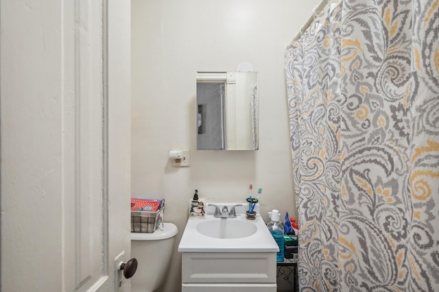 bathroom featuring vanity and toilet