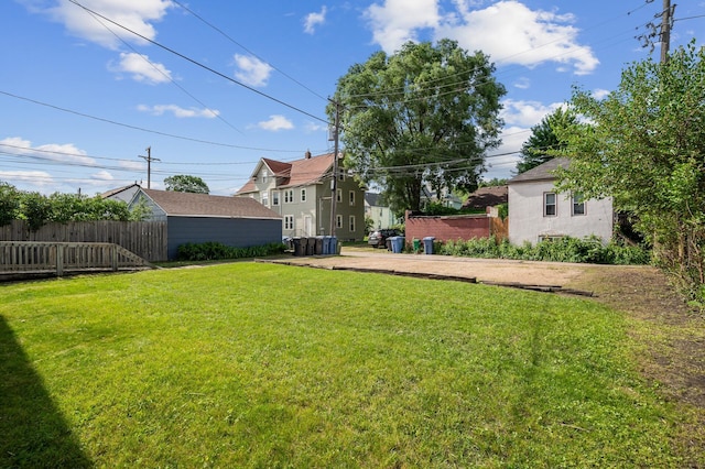 view of yard featuring fence and an outdoor structure