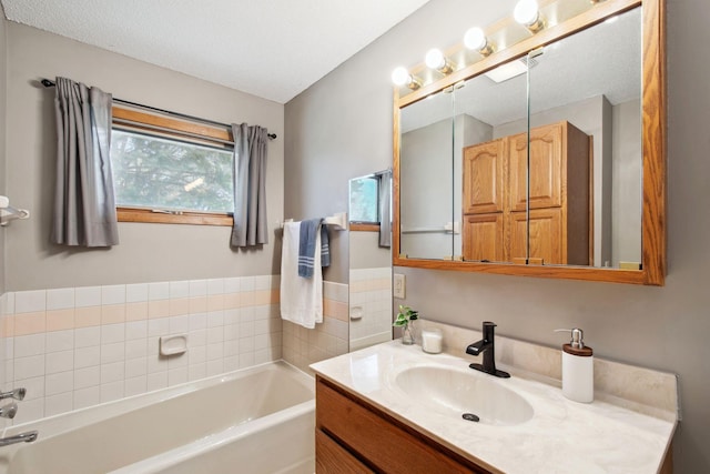 full bathroom featuring vanity and a bath