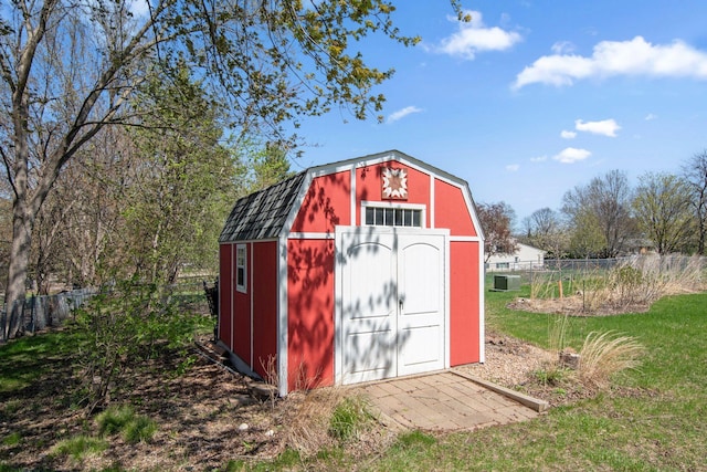 view of shed with fence and central AC unit