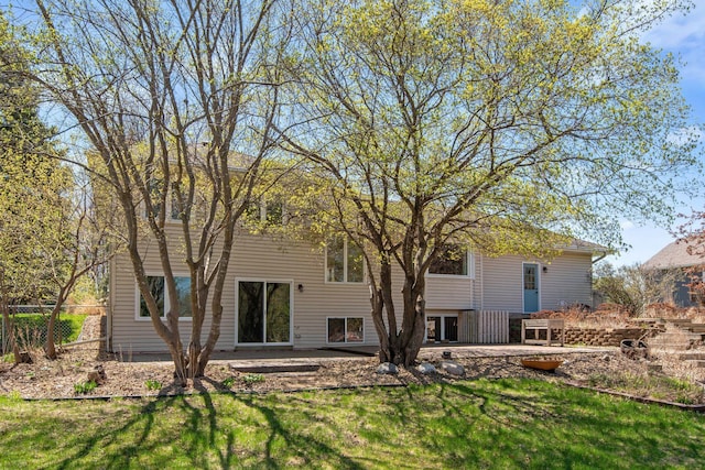 rear view of house with a lawn, fence, and a patio area