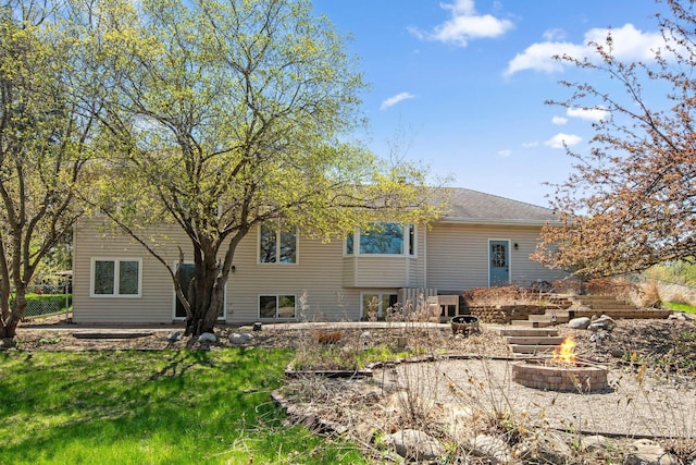 back of house with fence and an outdoor fire pit