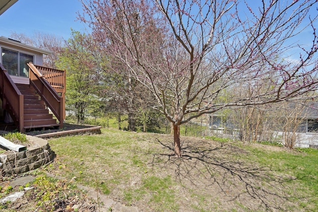 view of yard with a deck and stairway