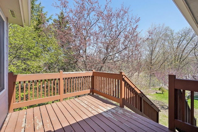 wooden terrace featuring visible vents