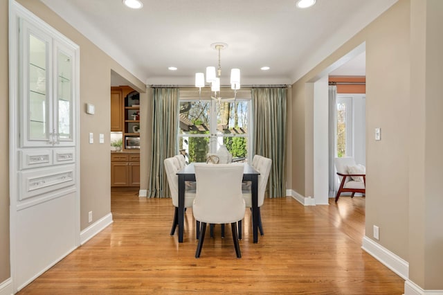 dining room with an inviting chandelier, baseboards, recessed lighting, and light wood-style flooring