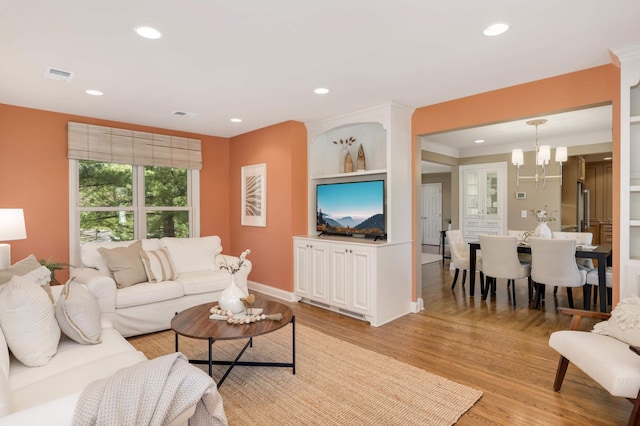 living area with recessed lighting, visible vents, and light wood finished floors