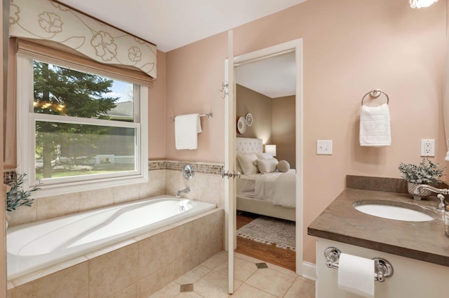 full bath featuring vanity, a bath, connected bathroom, and tile patterned floors