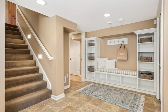 mudroom featuring baseboards and tile patterned flooring