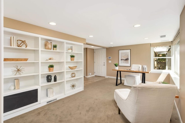 sitting room featuring visible vents, recessed lighting, and light colored carpet